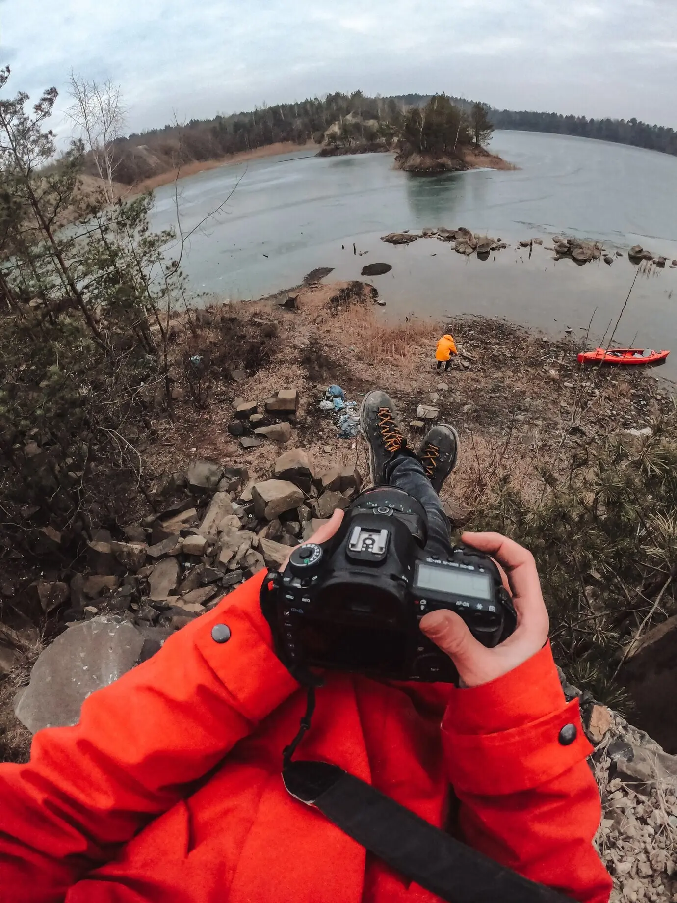 Der Typ steht am gefrorenen See.